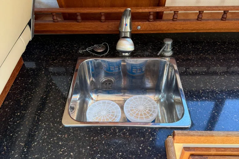 Slide: The Image of Stainless steel sink on 2010 Ranger Tugs R-25 boat with black countertop. - 33