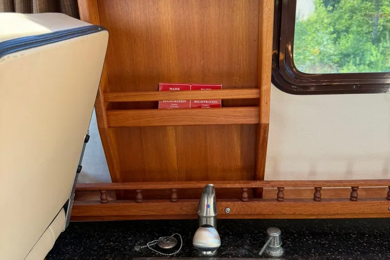 Slide: The Image of Interior of 2010 Ranger Tugs R-25 boat with wooden paneling and window view. - 34