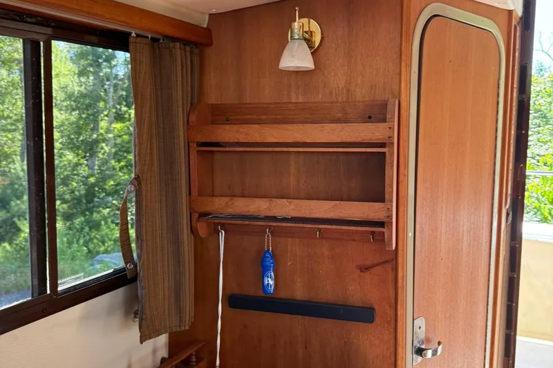 Slide: The Image of Interior of 2010 Ranger Tugs R-25 boat with wooden shelves and window view. - 39