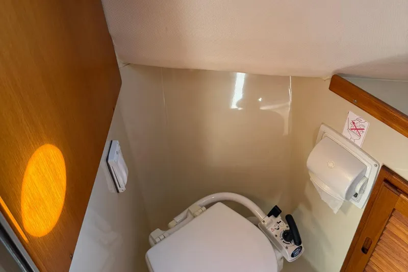 Slide: The Image of 2010 Ranger Tugs R-25 boat bathroom with toilet and paper holder. - 41