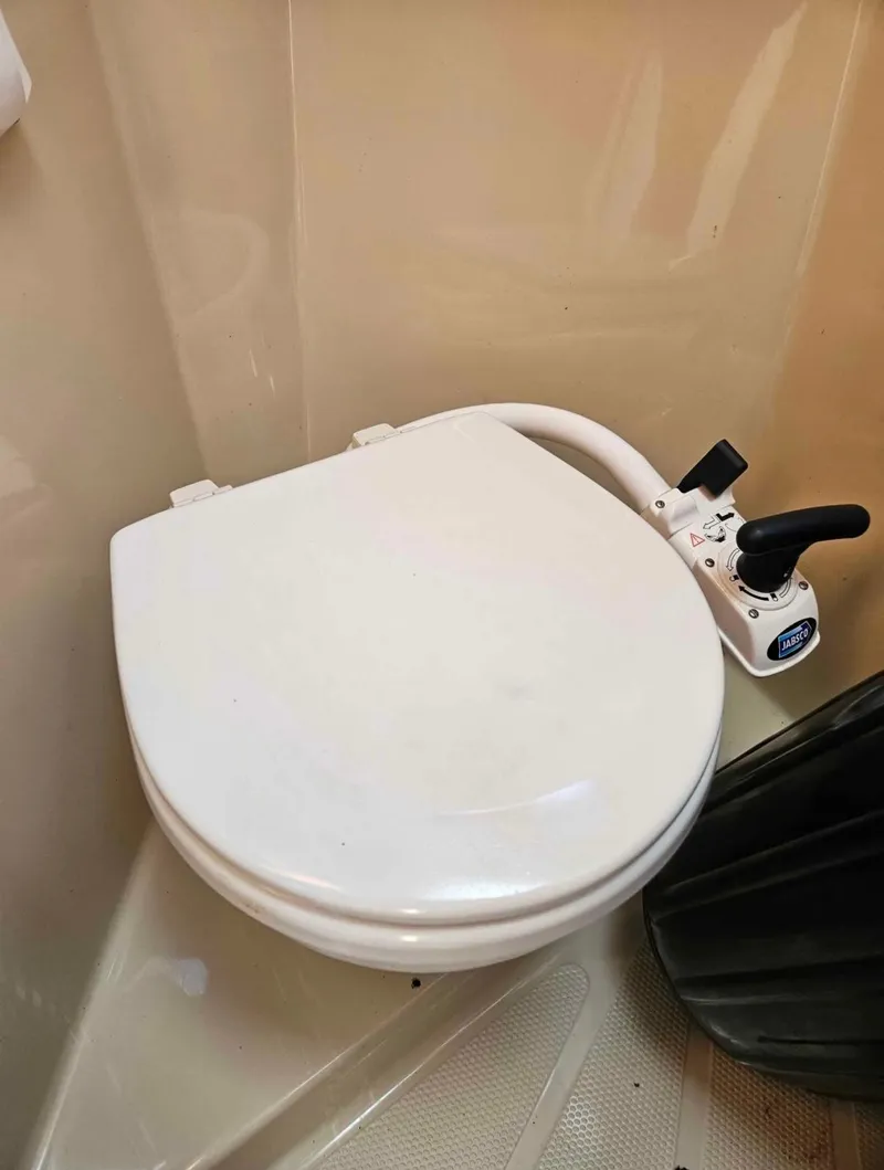 Slide: The Image of Marine toilet in 2010 Ranger Tugs R-25 boat, featuring manual flush controls. - 42