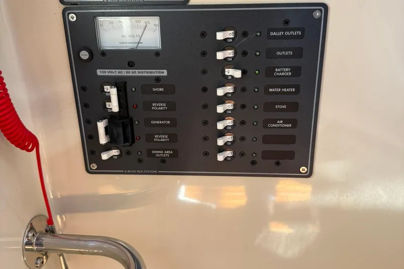 Slide: The Image of Electrical panel of a 2010 Ranger Tugs R-25 boat with various switches and indicators. - 44