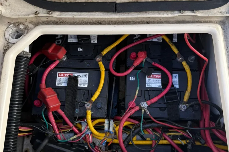 Slide: The Image of Battery compartment of a 2010 Ranger Tugs R-25 with wiring and connections. - 46