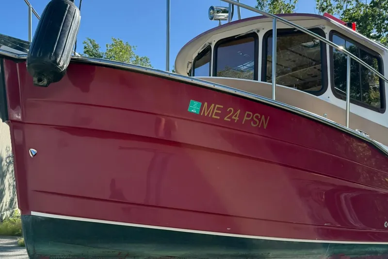 Slide: The Image of 2010 Ranger Tugs R-25 boat with red hull and registration ME 24 PSN. - 7