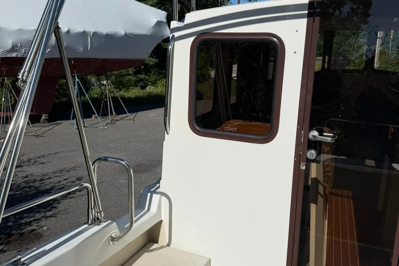 Slide: The Image of 2010 Ranger Tugs R-25 boat exterior with door and window detail. - 9