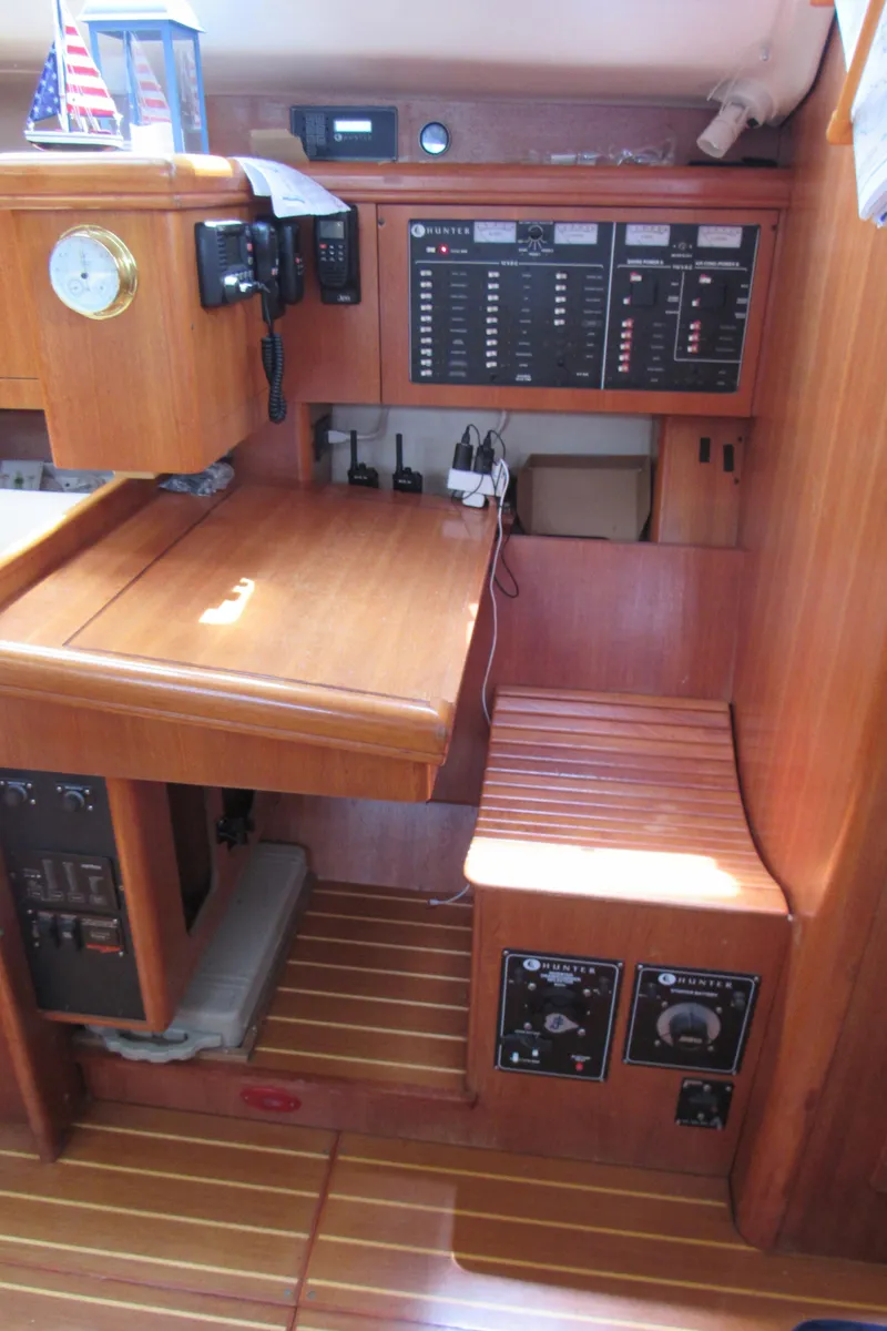 Slide: The Image of 2002 Hunter 466 yacht interior with navigation station and control panels. - 12
