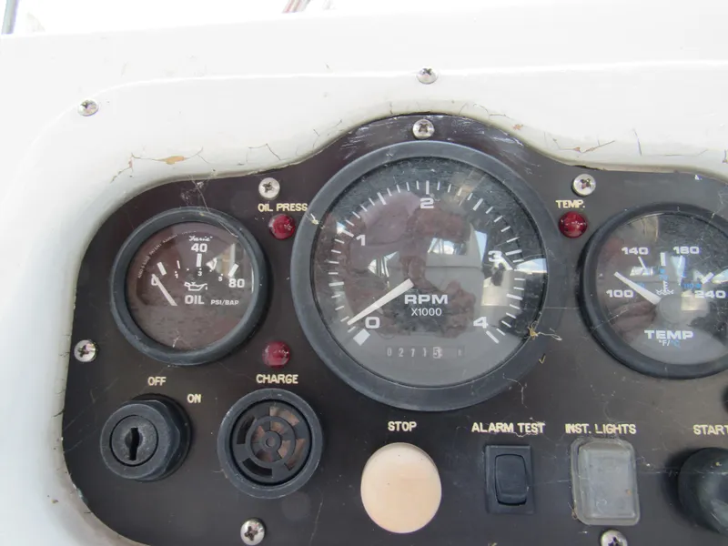 Slide: The Image of Control panel of a 2002 Hunter 466 boat, featuring oil, RPM, and temperature gauges. - 23