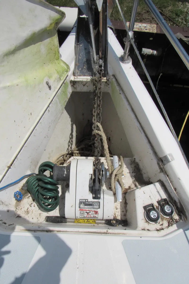 Slide: The Image of Anchor chain and winch on 2002 Hunter 466 sailboat deck. - 26