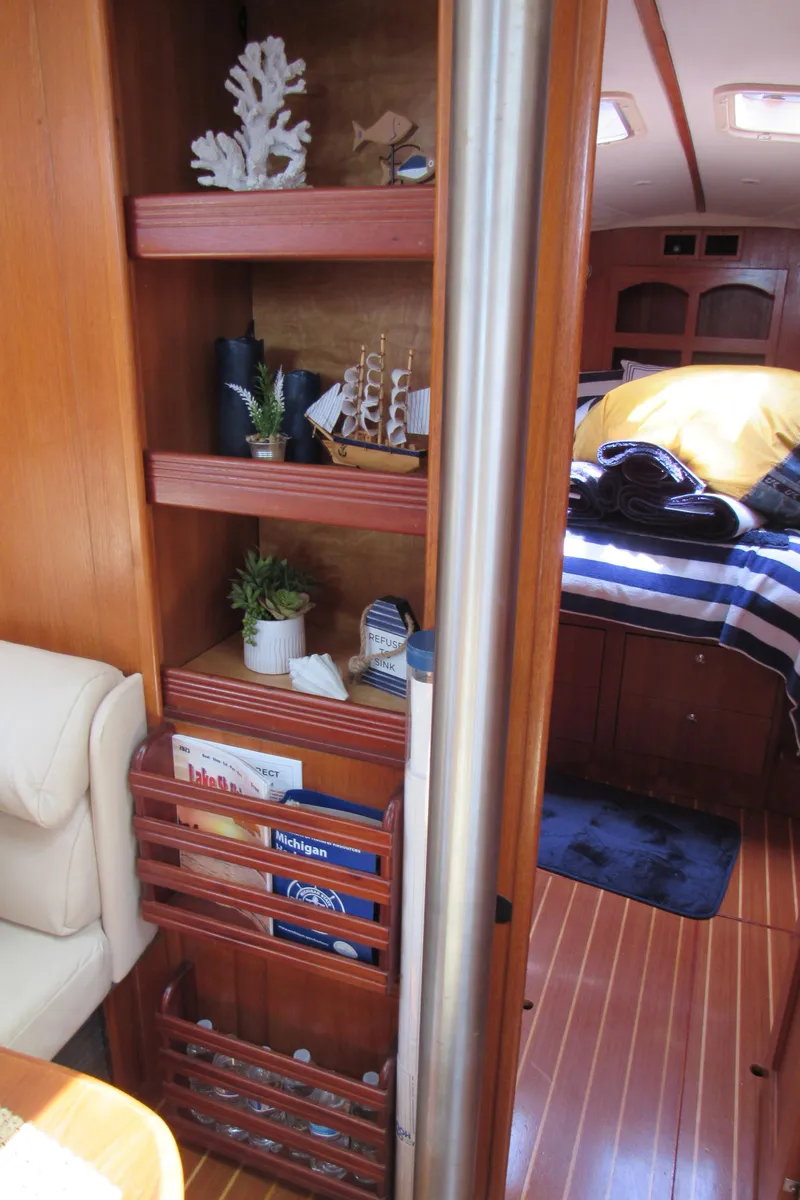 Slide: The Image of Interior of 2002 Hunter 466 yacht with wooden shelves and cozy cabin decor. - 27