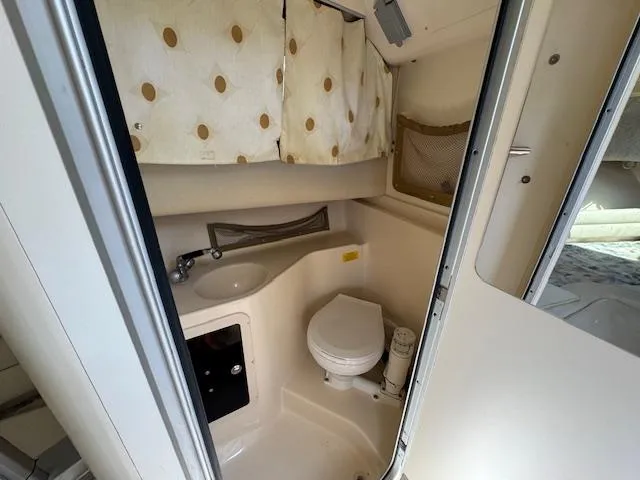 Slide: The Image of 2003 Grady-White Sailfish 282 boat bathroom with sink, toilet, and storage. - 15