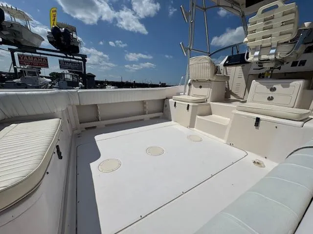 Slide: The Image of 2003 Grady-White Sailfish 282 boat interior with seating and clear sky background. - 5