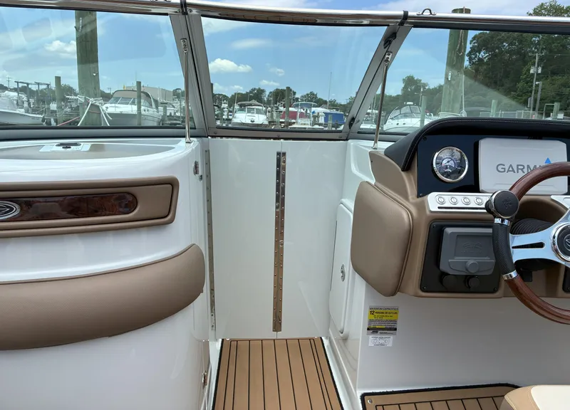Slide: The Image of 2022 Crownline Eclipse E235 XS boat interior with Garmin navigation system and sleek dashboard design. - 13