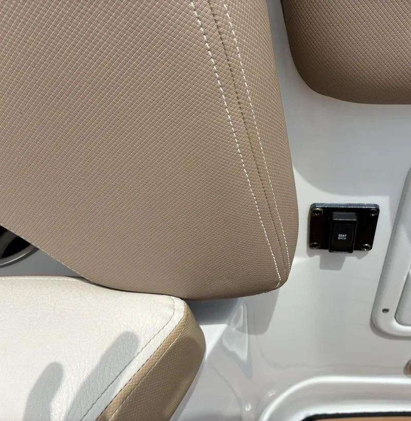 Slide: The Image of 2022 Crownline Eclipse E235 XS boat interior with beige and white upholstery detail. - 15