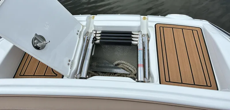 Slide: The Image of 2022 Crownline Eclipse E235 XS boat with open storage compartment and ladder. - 21