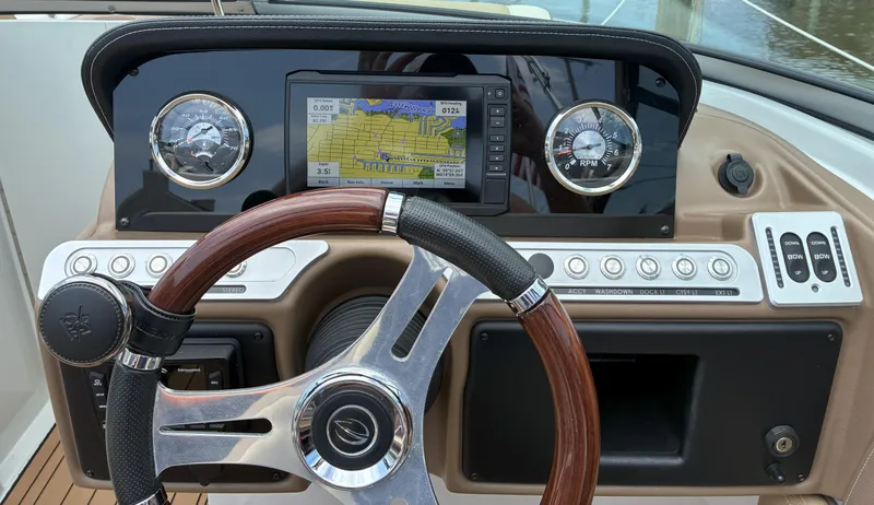 Slide: The Image of 2022 Crownline Eclipse E235 XS dashboard with GPS, gauges, and steering wheel. - 4