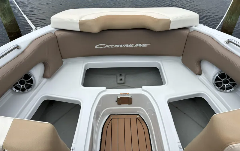 Slide: The Image of 2022 Crownline Eclipse E235 XS boat interior with tan seating and storage compartments. - 5