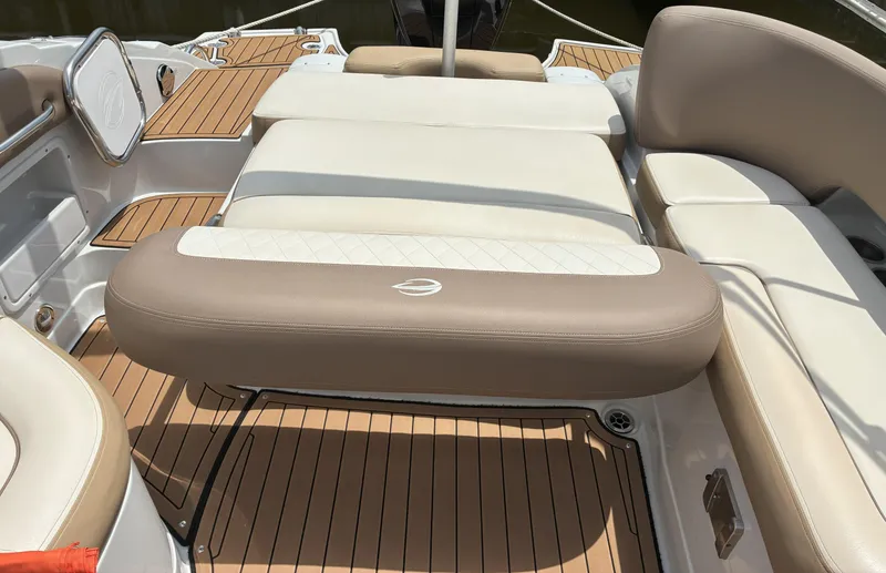 Slide: The Image of 2022 Crownline Eclipse E235 XS boat interior with beige seating and teak flooring. - 6