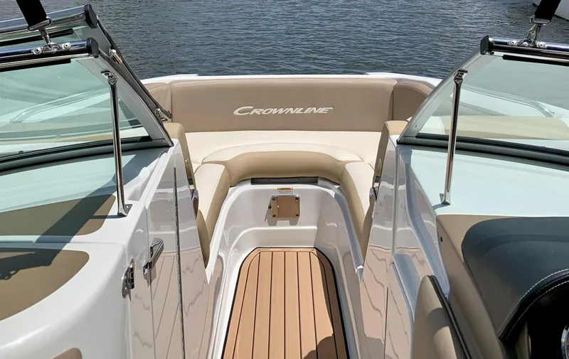 Slide: The Image of 2022 Crownline Eclipse E235 XS boat interior with tan seating and sleek design. - 7