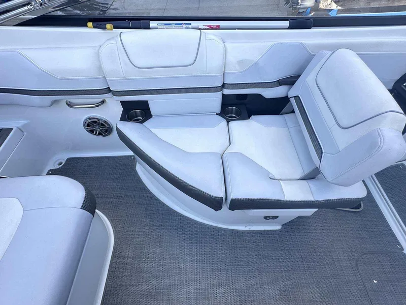Slide: The Image of 2016 Formula 240 Bowrider interior with white cushioned seating and gray flooring. - 10