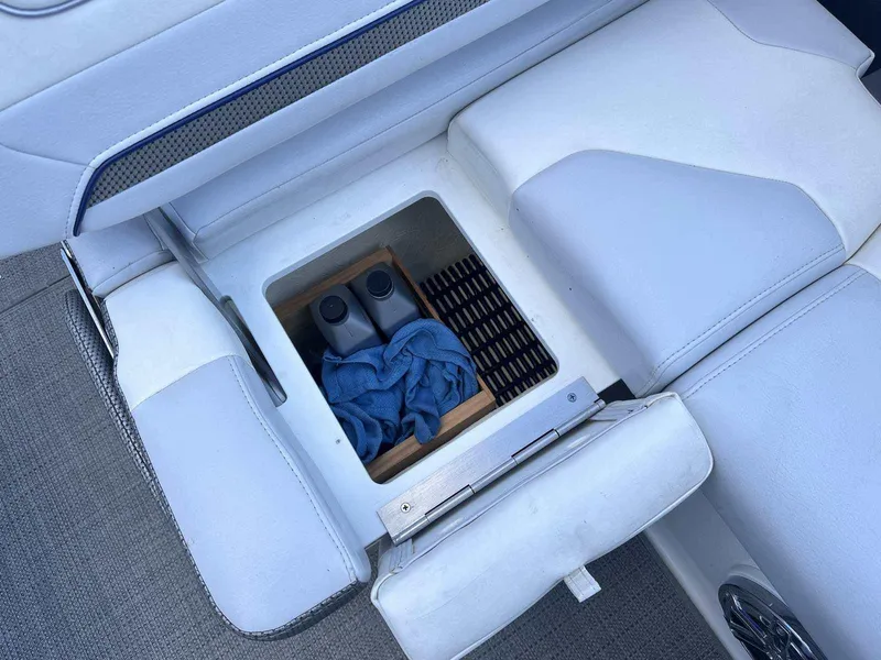 Slide: The Image of Storage compartment in 2016 Formula 240 Bowrider boat with bottles and cloth. - 12