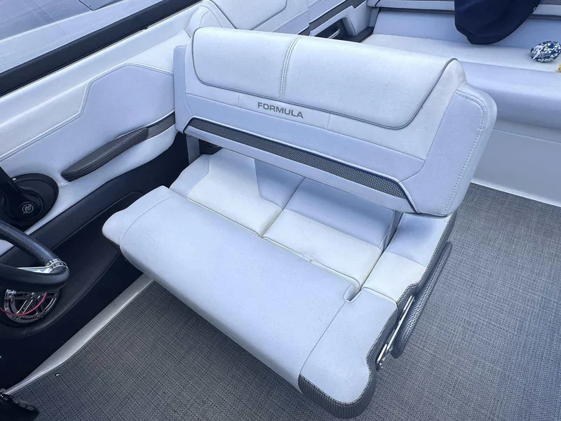Slide: The Image of 2016 Formula 240 Bowrider interior with white cushioned seating and sleek design. - 14