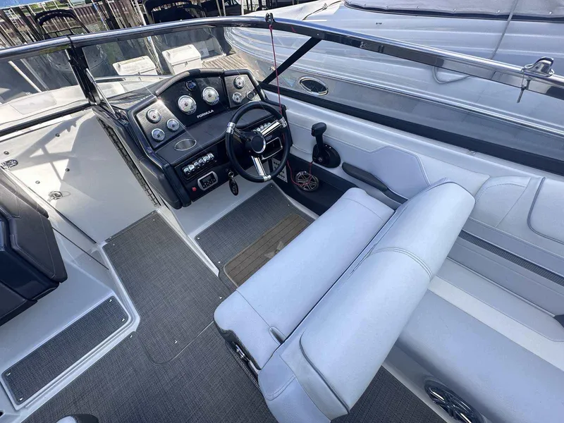 Slide: The Image of 2016 Formula 240 Bowrider cockpit with steering wheel and control panel. - 16