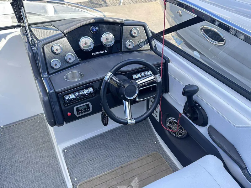 Slide: The Image of 2016 Formula 240 Bowrider dashboard with steering wheel and control panel. - 17