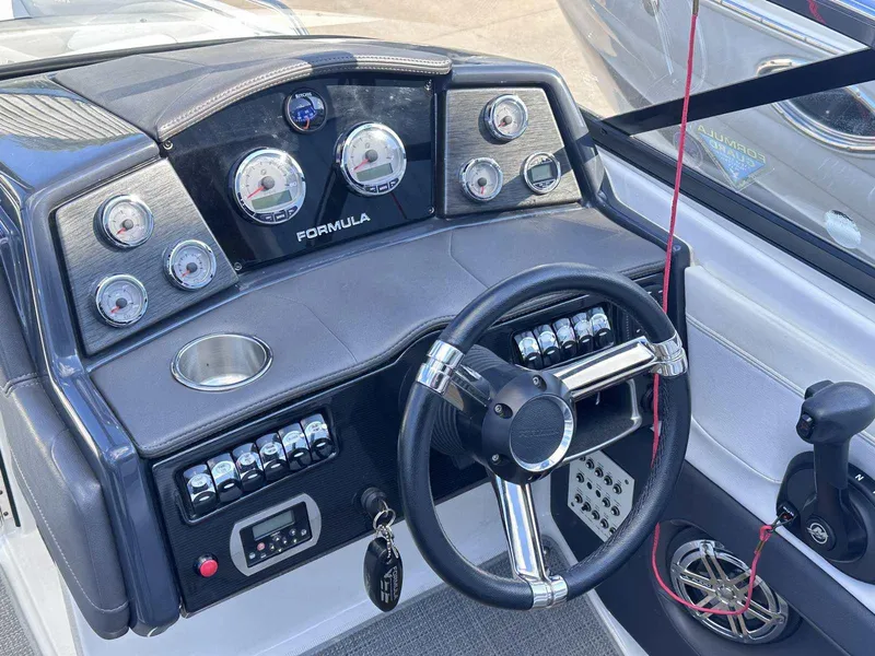 Slide: The Image of Dashboard of a 2016 Formula 240 Bowrider boat with steering wheel and gauges. - 18
