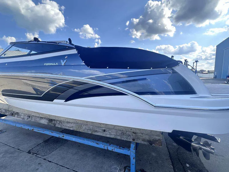 Slide: The Image of 2016 Formula 240 Bowrider boat on a dock under a blue sky with clouds. - 2