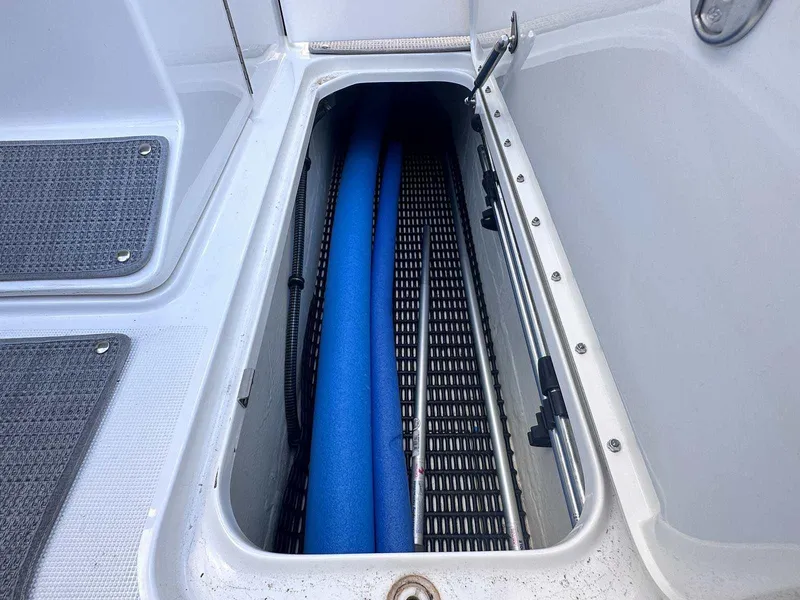 Slide: The Image of Storage compartment in 2016 Formula 240 Bowrider boat with blue pool noodles. - 20