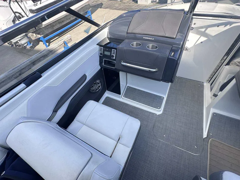 Slide: The Image of Interior of a 2016 Formula 240 Bowrider boat with seating and control panel. - 22