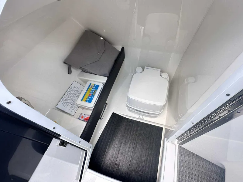 Slide: The Image of Interior of 2016 Formula 240 Bowrider boat with portable toilet and storage area. - 24