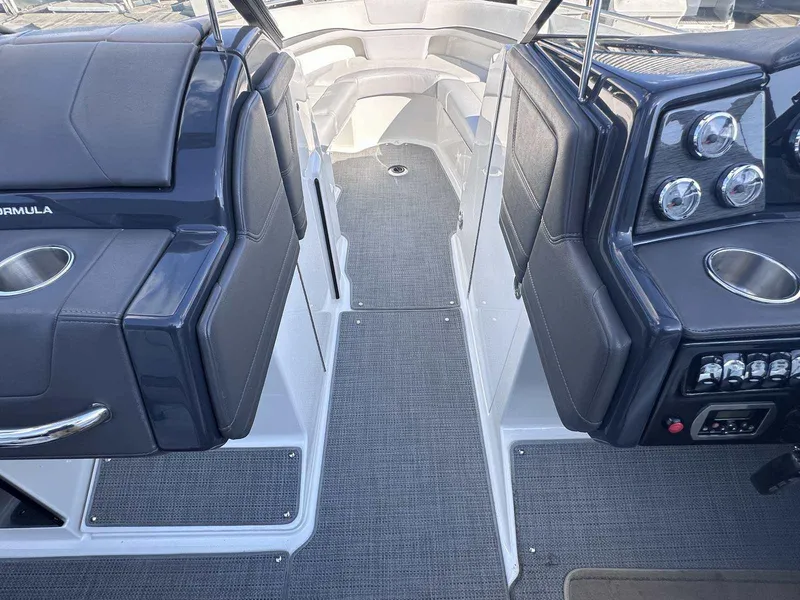Slide: The Image of Interior view of a 2016 Formula 240 Bowrider boat cockpit with seating and controls. - 25