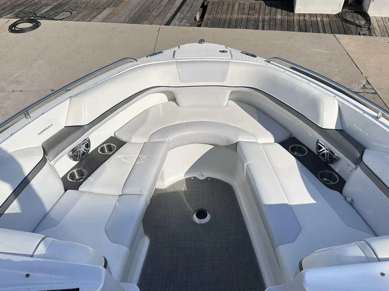 Slide: The Image of 2016 Formula 240 Bowrider boat interior with white seating and cup holders. - 27