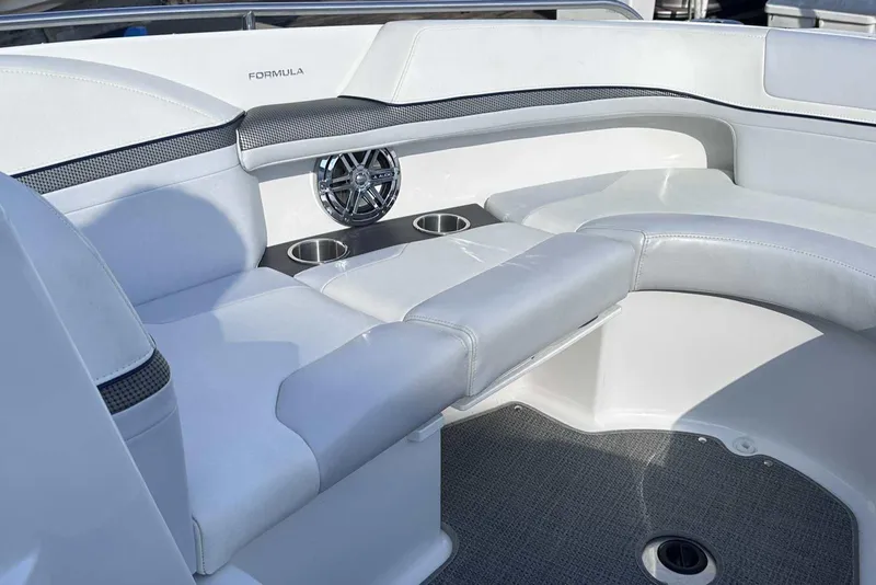 Slide: The Image of 2016 Formula 240 Bowrider interior with white seating, cup holders, and speaker. - 28