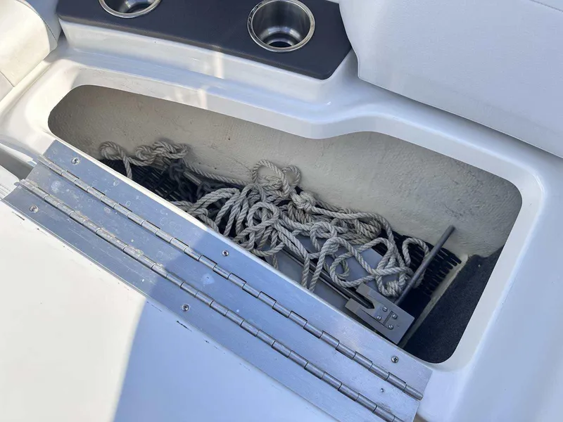 Slide: The Image of Storage compartment with ropes in a 2016 Formula 240 Bowrider boat. - 31
