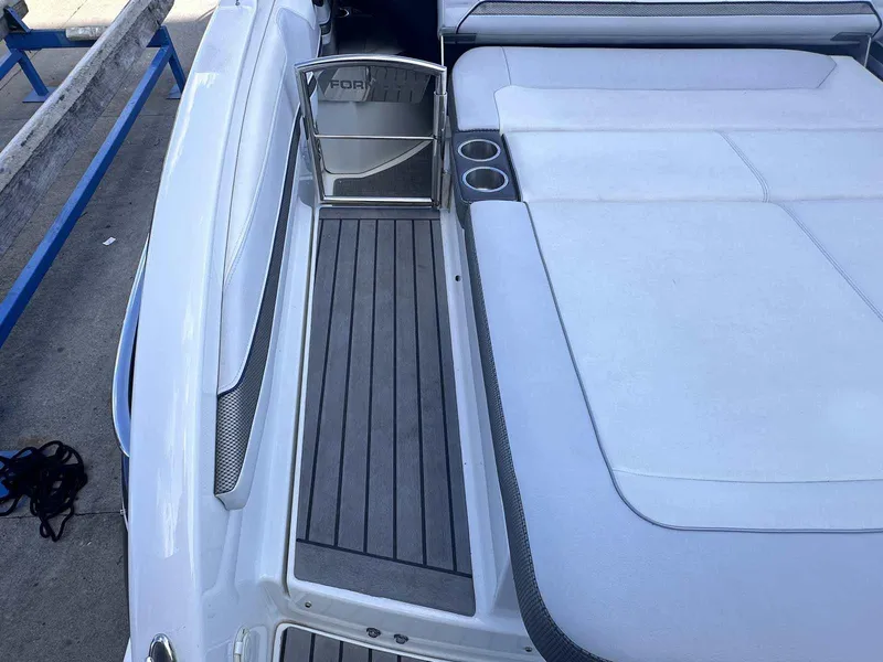 Slide: The Image of 2016 Formula 240 Bowrider boat interior with white seating and cup holders. - 8