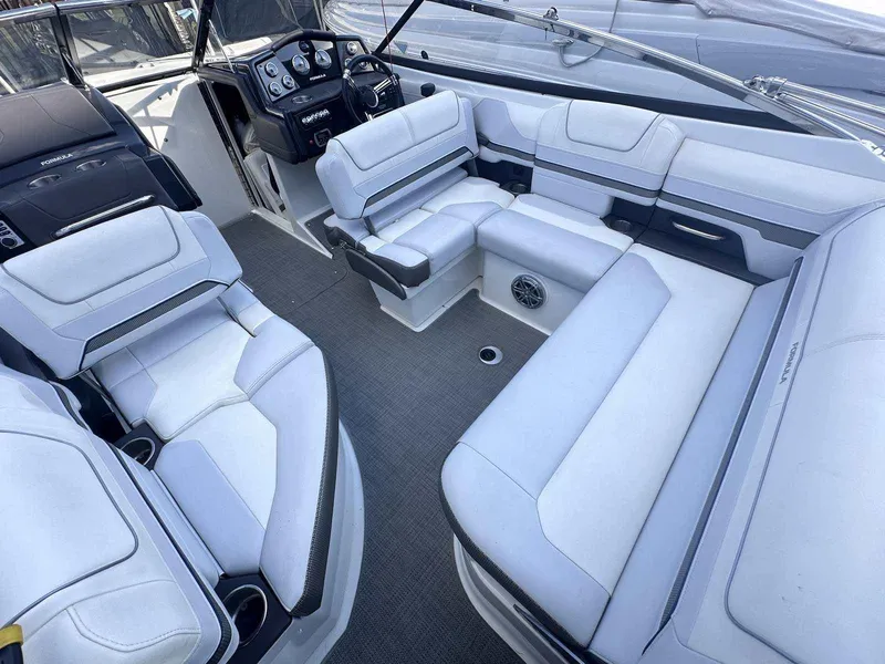Slide: The Image of 2016 Formula 240 Bowrider interior with white seating and modern dashboard. - 9