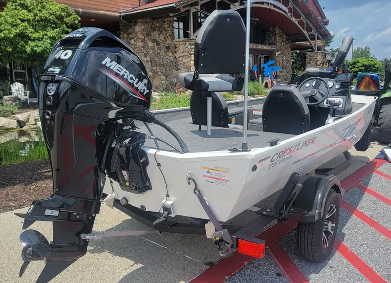 Slide: The Image of 2023 Crestliner 1700 Storm boat with Mercury engine, displayed outdoors. - 3