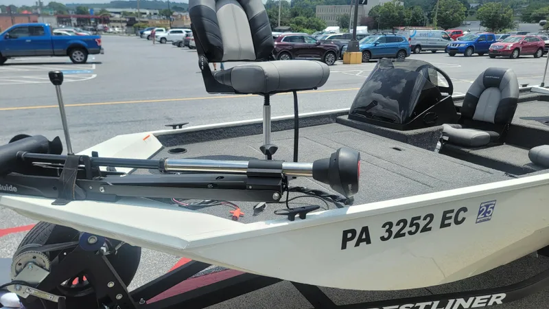 Slide: The Image of 2023 Crestliner 1700 Storm boat in parking lot, featuring seating and trolling motor. - 6