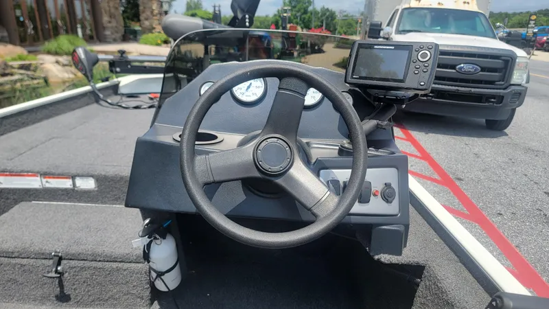Slide: The Image of 2023 Crestliner 1700 Storm boat dashboard with steering wheel and navigation system. - 7
