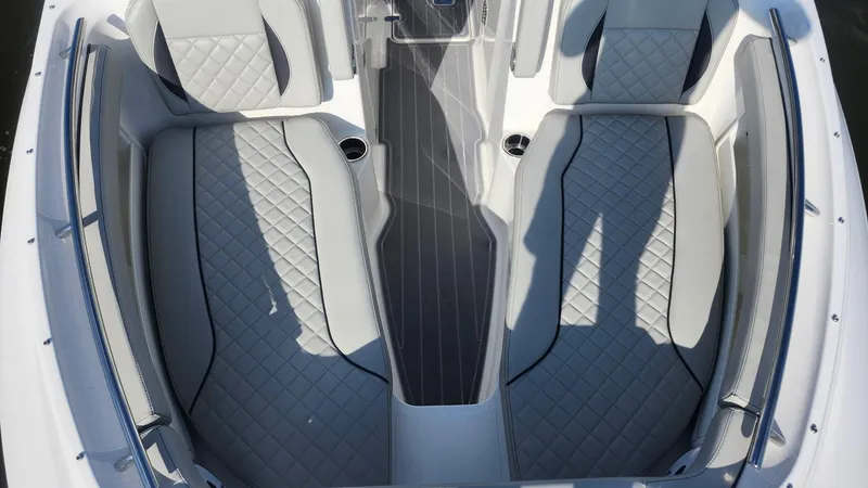 Slide: The Image of 2024 Pursuit DC 266 Dual Console boat interior with quilted seating and sleek design. - 10