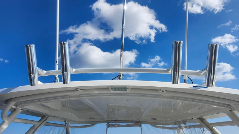 Slide: The Image of 2024 Pursuit DC 266 Dual Console boat against a bright blue sky with clouds. - 13