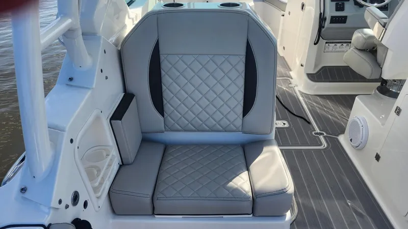 Slide: The Image of 2024 Pursuit DC 266 Dual Console boat interior with gray quilted seating. - 14