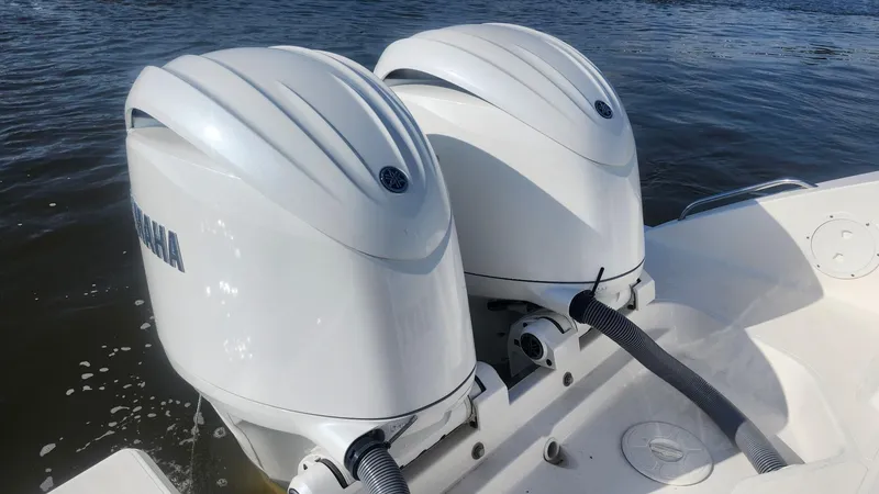 Slide: The Image of 2024 Pursuit DC 266 Dual Console with twin Yamaha outboard motors on water. - 20