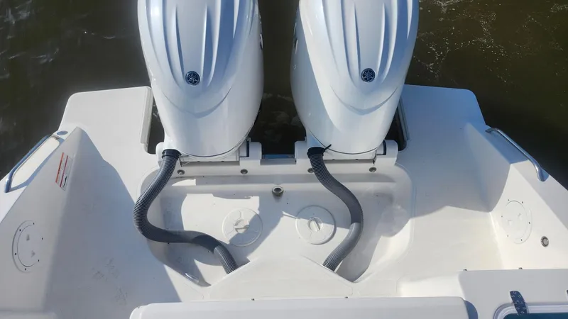 Slide: The Image of 2024 Pursuit DC 266 Dual Console boat with twin outboard engines. - 21