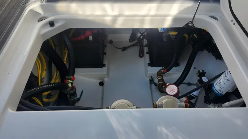 Slide: The Image of 2024 Pursuit DC 266 Dual Console engine compartment with visible wiring and components. - 23