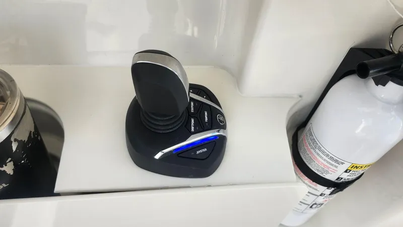 Slide: The Image of Joystick control and fire extinguisher on 2024 Pursuit DC 266 Dual Console boat. - 3