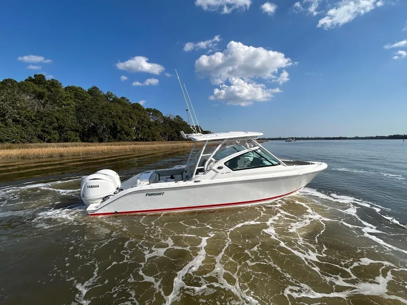 Slide: The Image of 2024 Pursuit DC 266 Dual Console boat cruising on a sunny day with clear skies. - 37