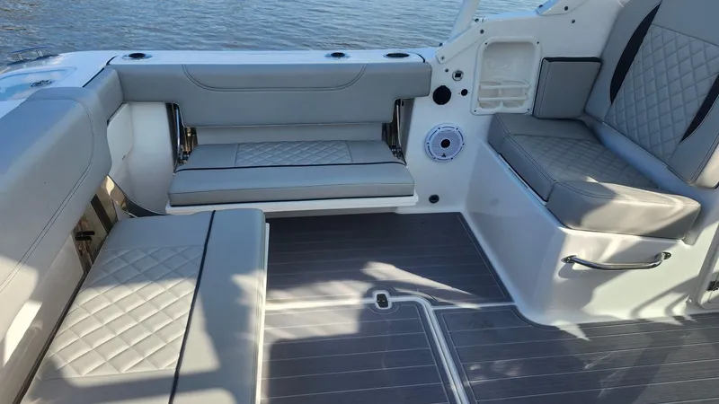 Slide: The Image of 2024 Pursuit DC 266 Dual Console boat interior with gray cushioned seating and sleek design. - 6
